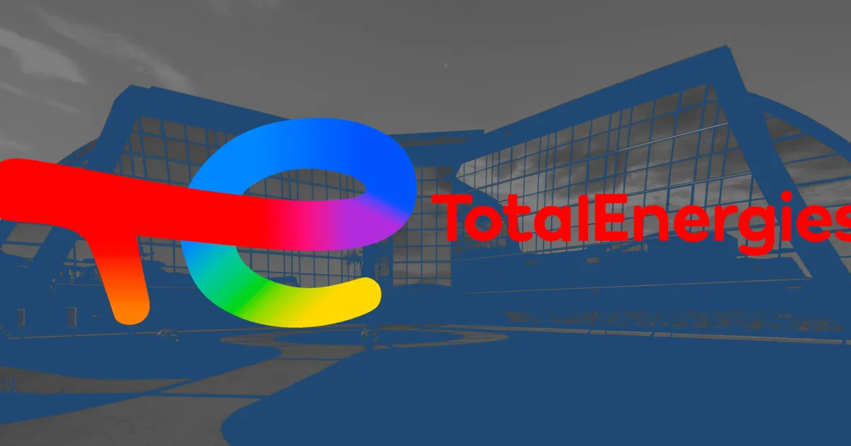 Rainbow-coloured TotalEnergies logo over a blue-tinted photo of a glass building